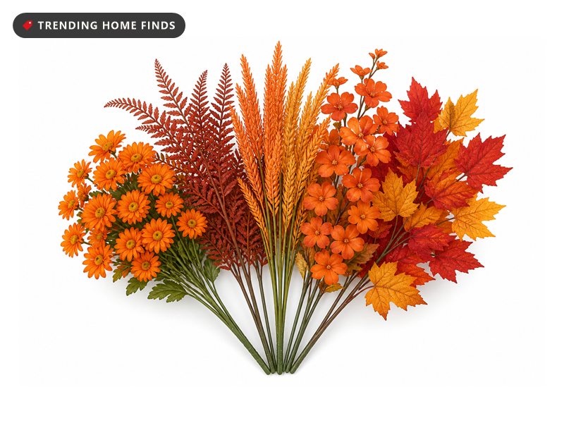 Orange mums, rust ferns, wheat spikes and red maple leaf stems filling a white porch planter box.