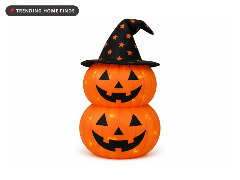 Three foot stacked two tier jack o lantern in ribbed orange fabric with black cut faces and a black star print witch hat on top.