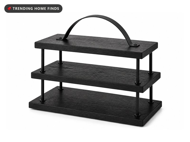 A three tier stand of black stained wood boards held apart by slim black steel posts with an arched carry handle on top.