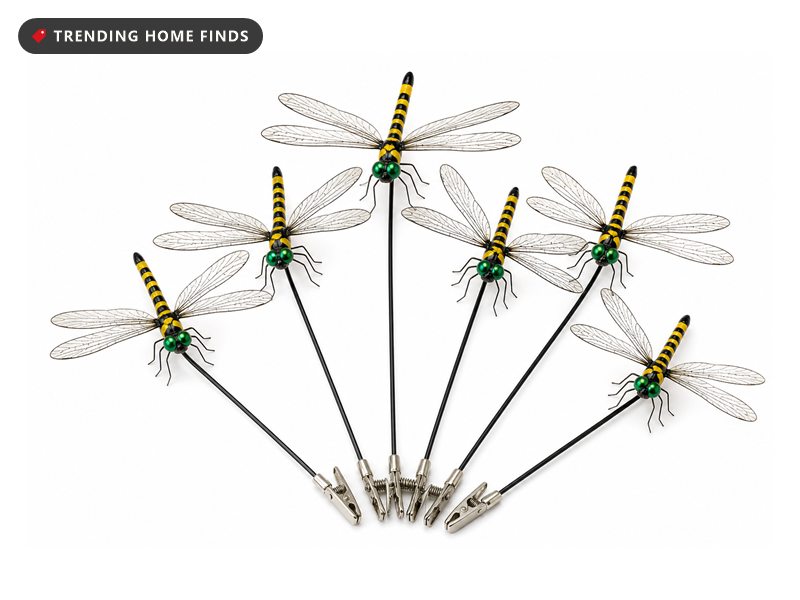 Ornamental dragonfly garden stakes with black and yellow bodies, green eyes and veined translucent wings on wire stems.