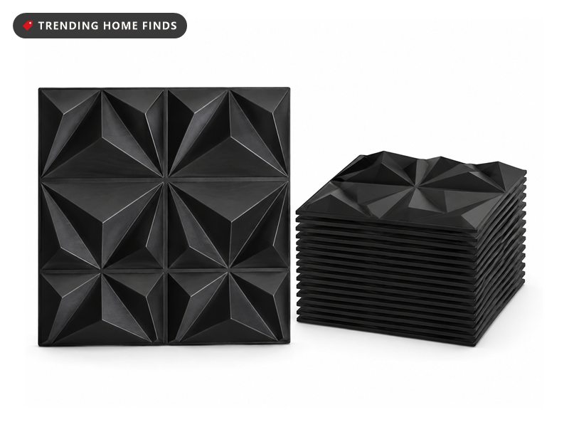 Stack of black diamond-textured square 3D wall panels with one panel standing upright showing its faceted surface