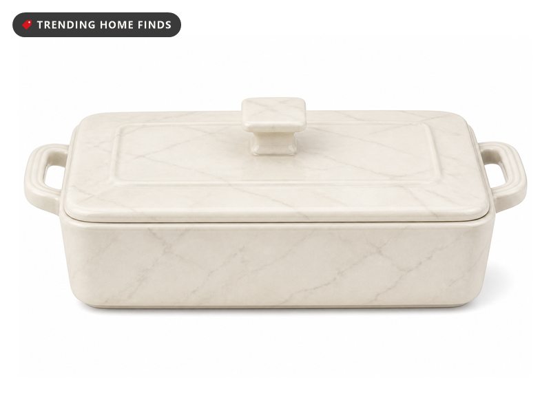 A cream and gray marble look ceramic casserole dish with deep sides, loop handles and a matching lid.