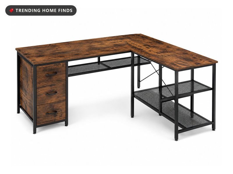 L shaped desk with a rustic brown wood grain top on a black metal frame, three fabric drawers under one side and open mesh shelves at the end