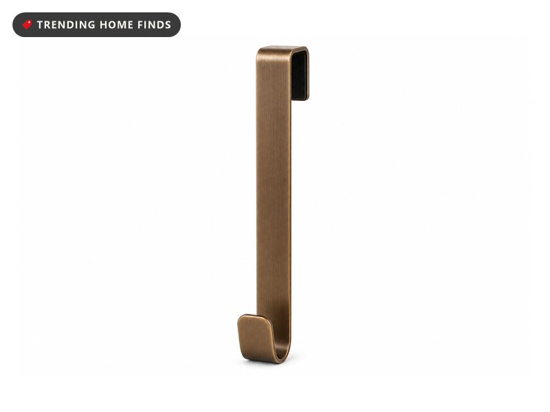 A bronze over the door wreath hanger with a top clip and lower hook.