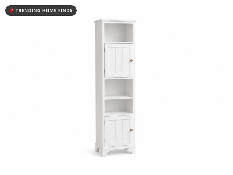 Tall narrow white cabinet with fluted doors top and bottom, brass knobs and two open shelves through the middle.