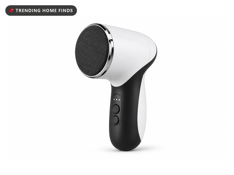 White and black handheld foot callus remover with a round dark grit sanding disc and two control buttons.