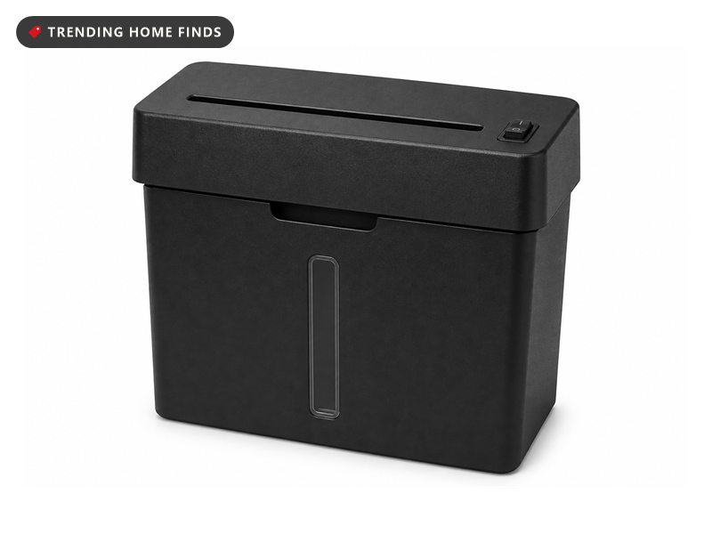 Black paper shredder with a wider head on a narrower bin, a long feed slot across the top and a window down the front.