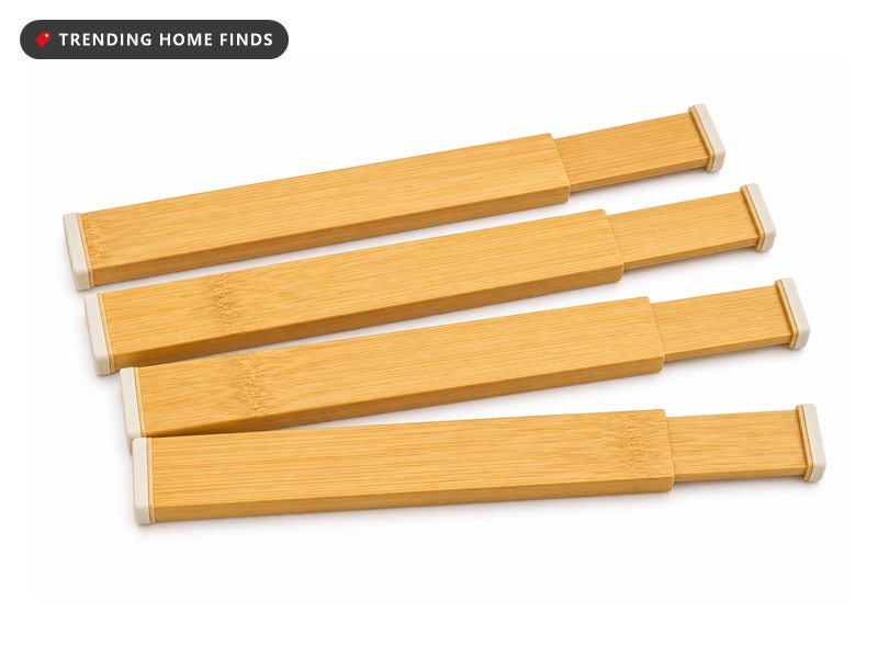 Four natural bamboo divider bars fanned out, each with a sliding telescoping joint and a pale rubber pad on both tips.