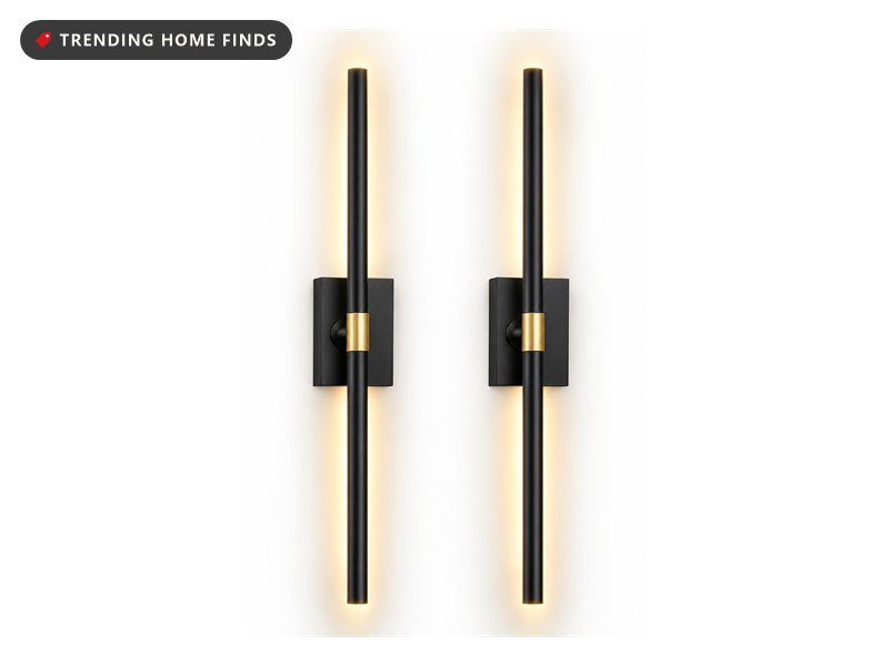 Two slim black battery powered wall light bars with gold accents, shown with a remote