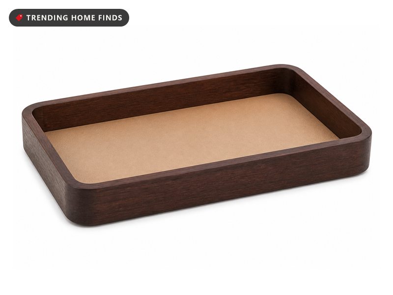 A shallow dark brown beech wood tray with thick rounded walls and a smooth tan leatherette lining.
