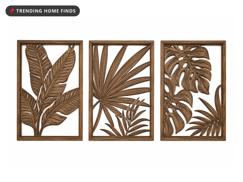 Set of three framed wood wall art panels with carved cut-out banana, palm and monstera leaves in a warm walnut finish