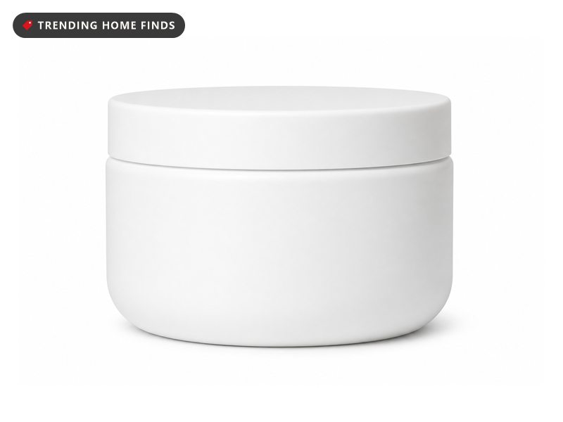 A plain 8 ounce mask jar open on a clay tile shower shelf beside a wide tooth comb and a folded waffle towel, grey rainy window light.
