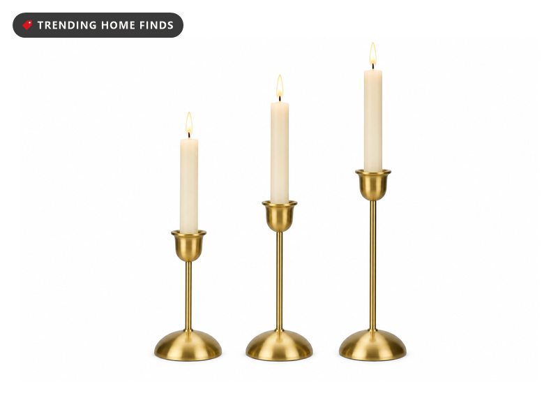 Three slim brass candlesticks in stepped heights.