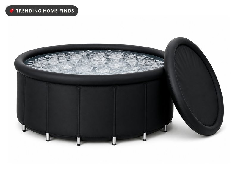 Round black ice bath tub filled with iced water on a metal frame, with its padded lid leaning against the side