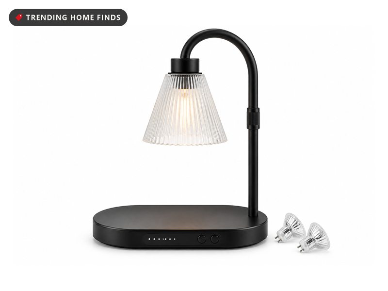Black candle warmer lamp glowing over a candle jar, with a timer base and two spare bulbs