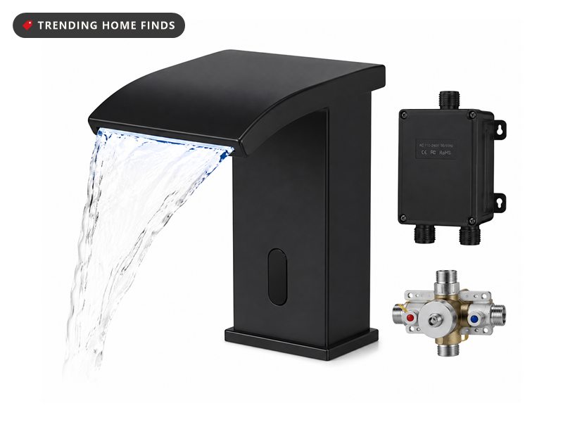 Matte black touchless waterfall bathroom faucet with water sheeting from the wide spout, shown with its control box and mixing valve