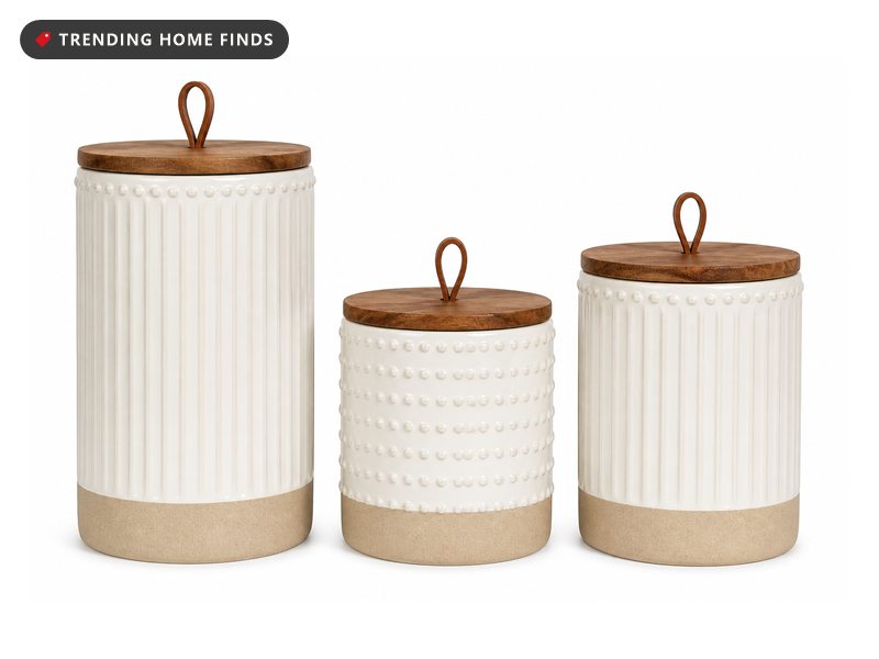 Three warm white ceramic canisters with raised patterns, raw clay bases and flat acacia wood lids.