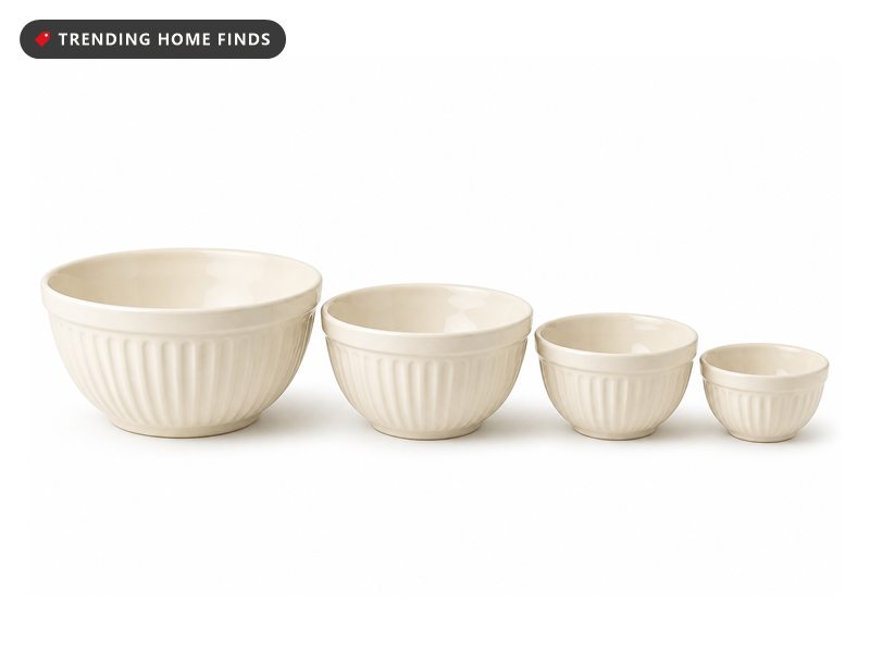 Four ivory embossed stoneware mixing bowls in graduated sizes, nested open in a row.