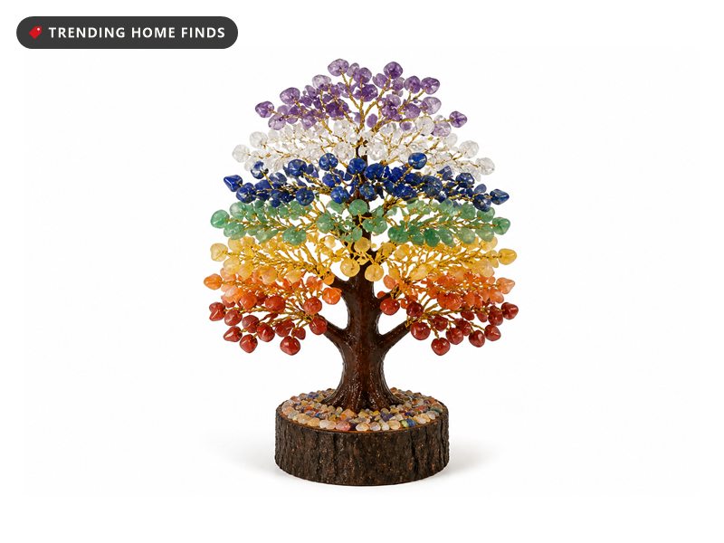Decorative wire tree with seven colours of tumbled gemstone leaves on gold branches, on a carved wood base, beside its dark green gift box