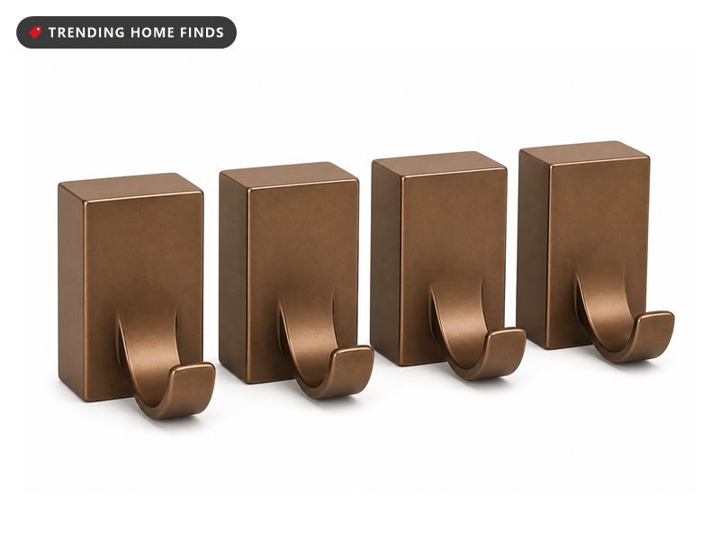 Four bronze weighted Christmas stocking holders with hooks curving forward.