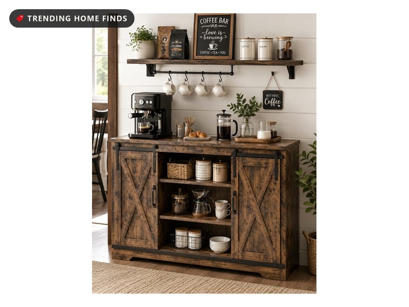 Rustic brown wood coffee bar cabinet with sliding barn doors and open shelving, styled with an espresso machine, glass canisters and hanging mugs against a white wall