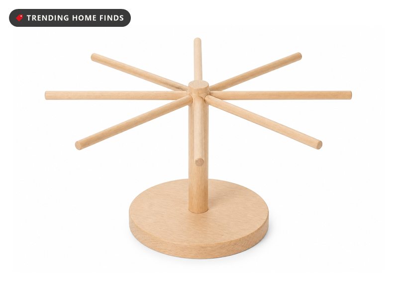 A pale beechwood pasta drying rack with horizontal arms radiating from a center post.