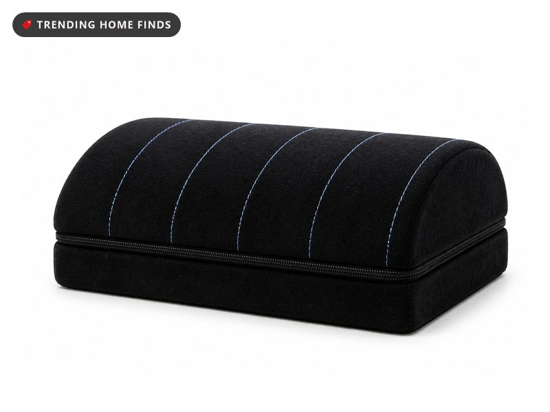 Black memory foam foot rest with a ribbed top and a removable lower layer for height adjustment