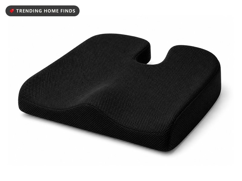 ComfiLife U-shaped seat cushion showing its blue gel top layer and black covered side, a hand pressing into the foam.