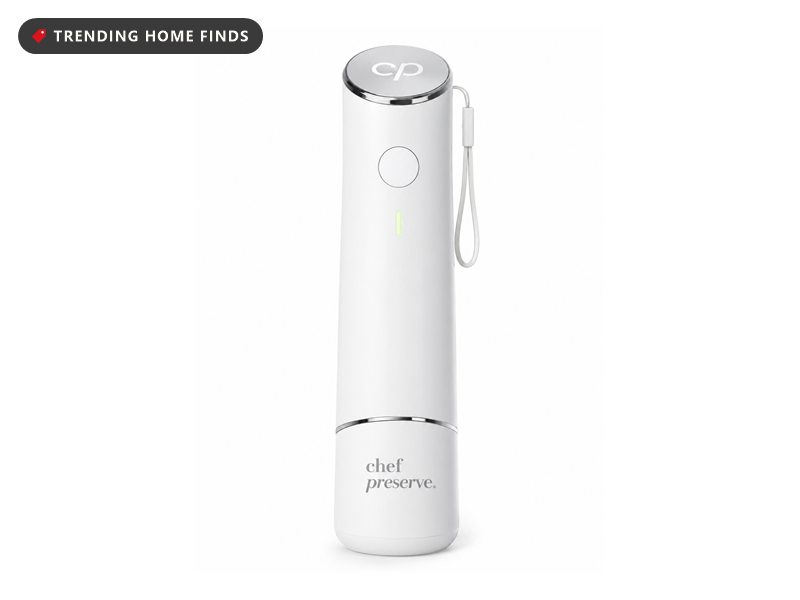 Slim white Chef Preserve handheld vacuum sealer with a single round button and a wrist strap