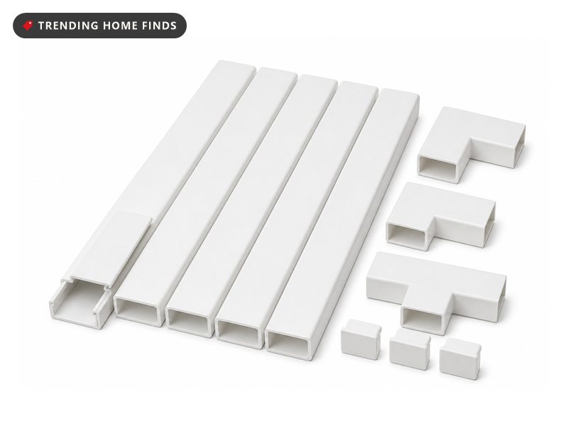 A set of plain white plastic cord cover channels with corner pieces and end caps, one channel open to show the hollow inside.