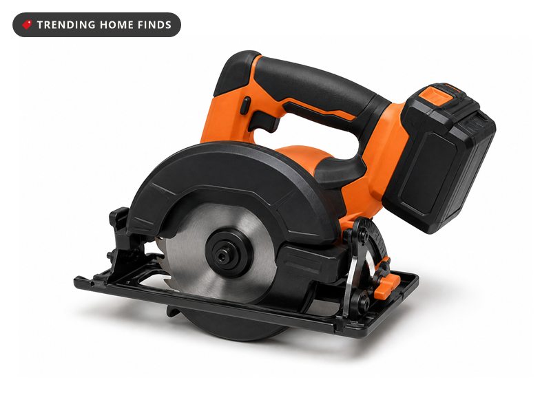 Compact cordless circular saw in matte black and orange with a small blade guard and battery clipped in.