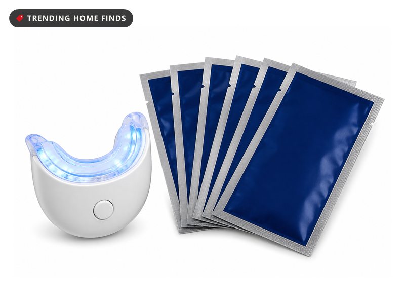 Crest 3D Whitestrips Professional Effects box with a blue LED whitening light and a stack of foil strip packets