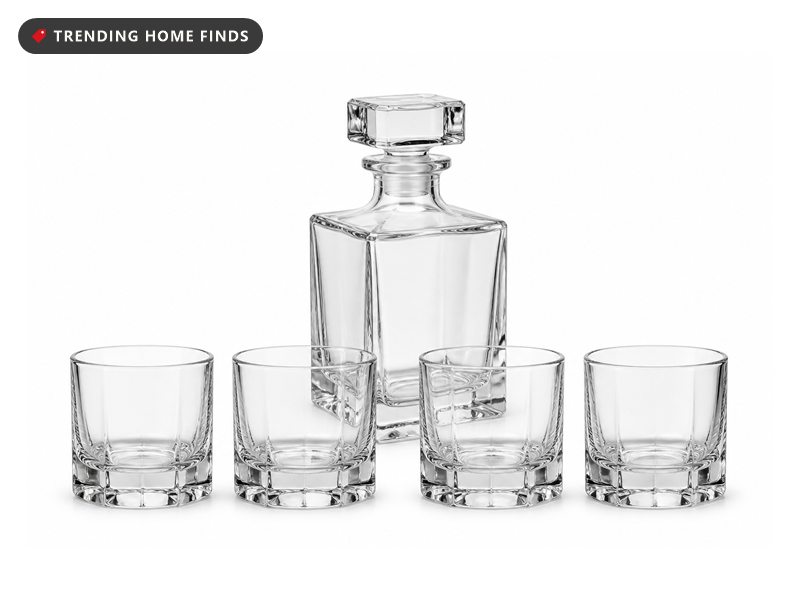 A faceted glass whiskey decanter with four glasses.