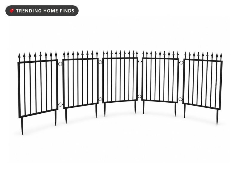 Five black iron fence panels with pointed picket tops standing in a curved line with spikes below.