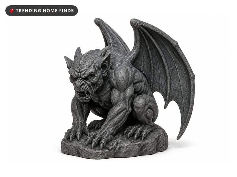 A weathered dark gray resin gargoyle statue with folded wings and flexed haunches, crouched on a rock base.
