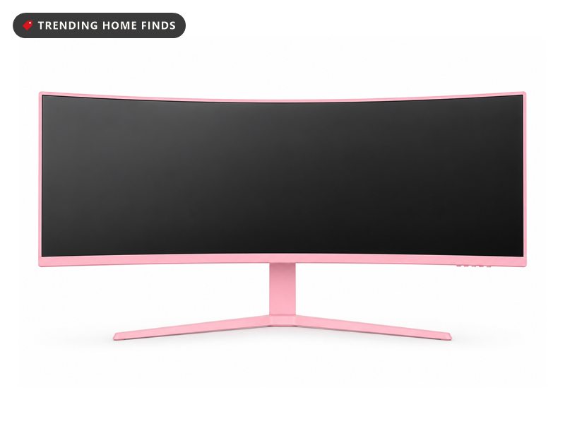 Pink 34 inch curved ultrawide monitor on a matching pink stand, showing a pink and purple cityscape with cherry blossom trees, overlaid with specification text reading WQHD 3440 by 1440 and 165Hz