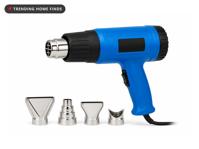 A bright blue heat gun with a black ribbed barrel and four chrome nozzle attachments beside it.