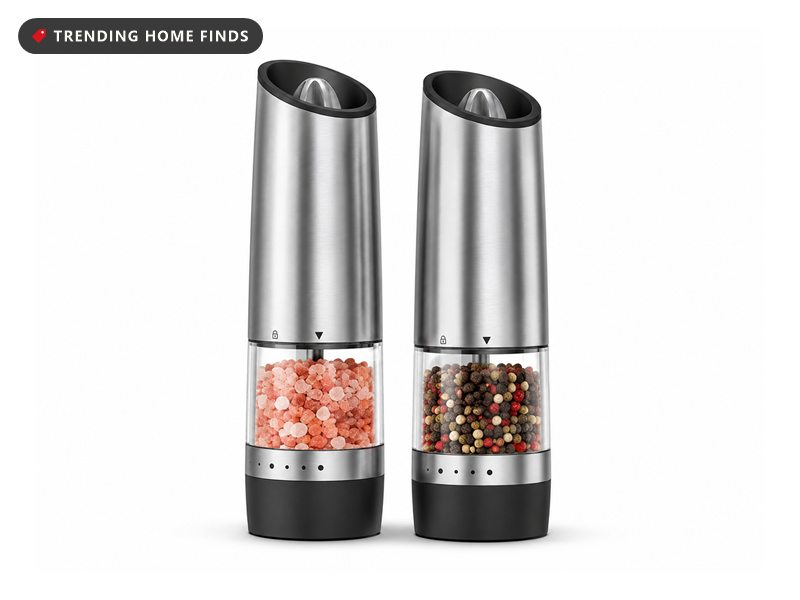 Set of two electric gravity salt and pepper grinders with stainless steel bodies and clear chambers, one filled with pink salt and the other with mixed peppercorns