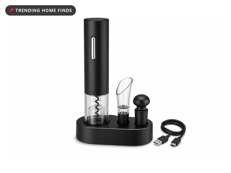 Black electric wine opener on its charging base with foil cutter, aerator and two vacuum stoppers arranged beside it