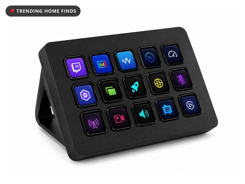 Black Elgato Stream Deck on an angled desktop stand, its fifteen backlit keys showing colourful app icons