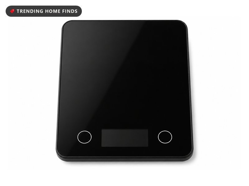 Black glass Etekcity digital kitchen scale with a lit display reading 0.00 and round unit and tare buttons on either side