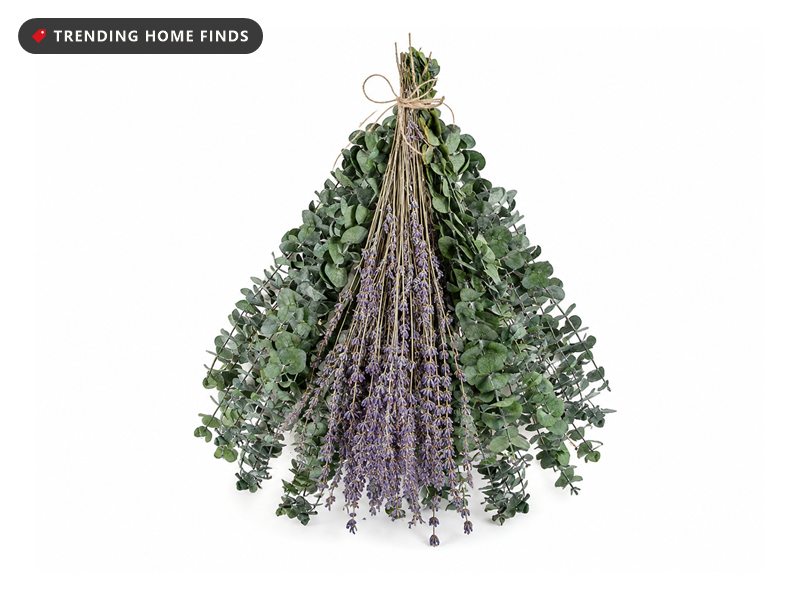 Hanging bundle of preserved eucalyptus stems and lavender flowers tied with twine