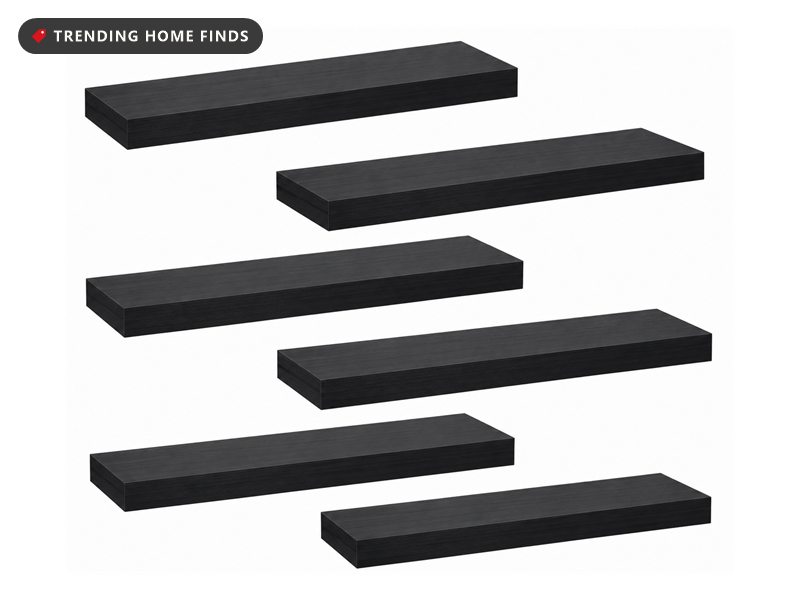 Six black wood-grain floating wall shelves arranged in a staggered pattern on a white background