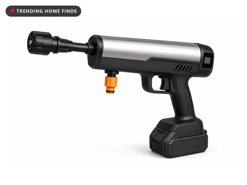 Compact pistol-shaped cordless pressure washer with a silver barrel, black grip battery and orange hose fitting.