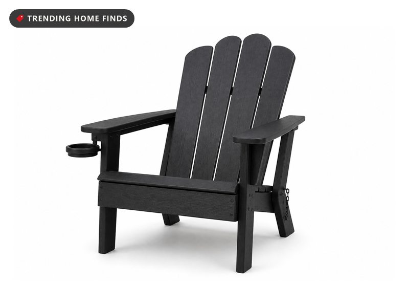 A black folding Adirondack chair with four fan shaped back slats, wide flat arms and a pull out cup holder.