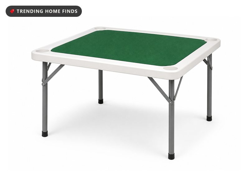 A square folding card table with a green felt top and white border.