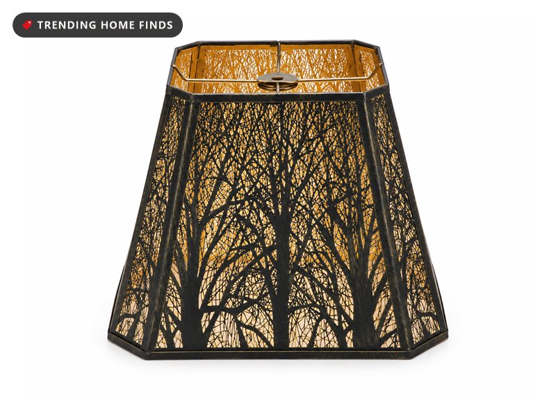 Rectangle black metal lampshade with laser cut tree silhouettes glowing warm amber from inside