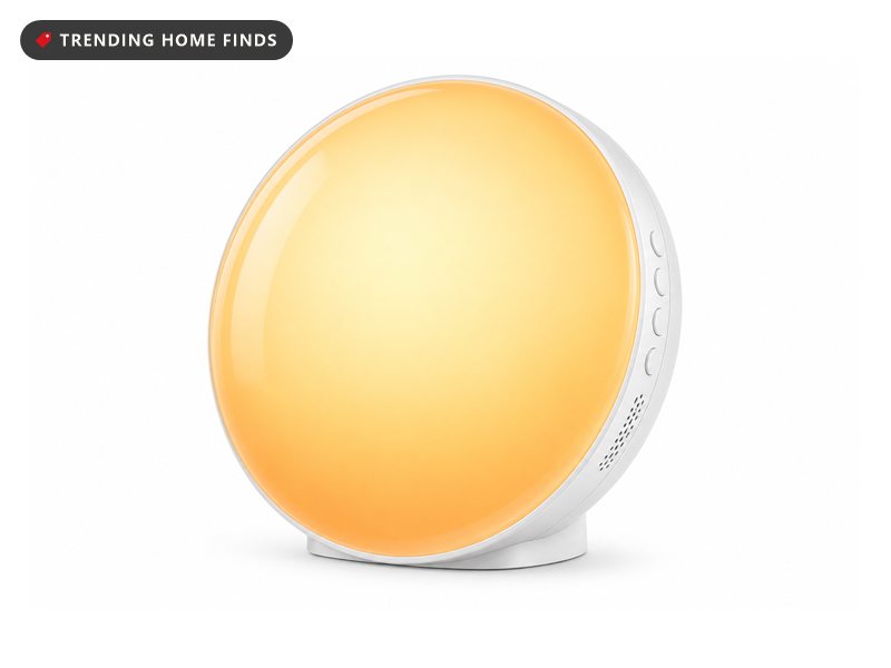 Round sunrise alarm clock glowing warm orange and showing 7:30
