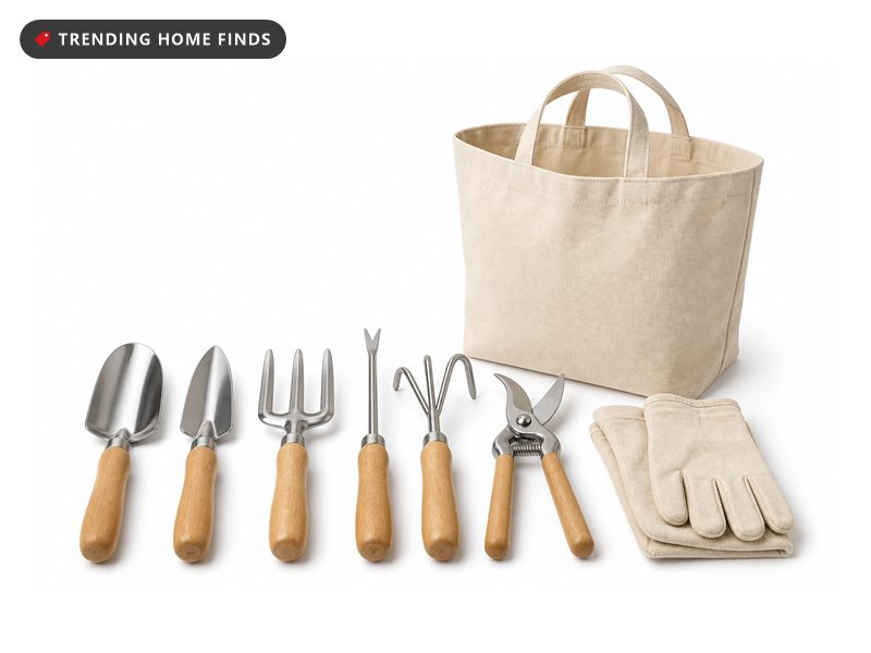 Six garden hand tools with wooden handles laid in a row beside gloves and a canvas tote.