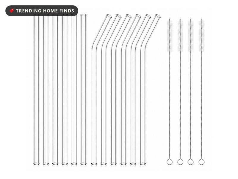 Twelve clear glass drinking straws, six straight and six bent, laid out beside four thin cleaning brushes